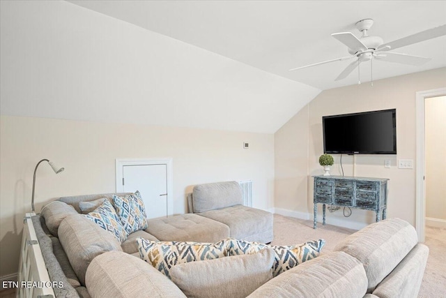 carpeted living area with a ceiling fan, baseboards, and vaulted ceiling