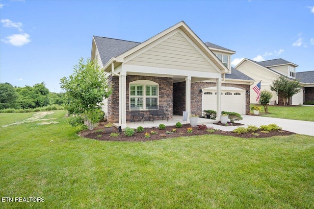 view of front of property featuring stone siding, driveway, an attached garage, and a front lawn