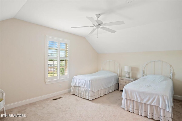 carpeted bedroom featuring visible vents, baseboards, ceiling fan, and vaulted ceiling