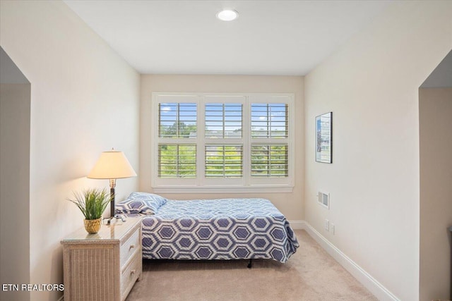 carpeted bedroom with visible vents and baseboards