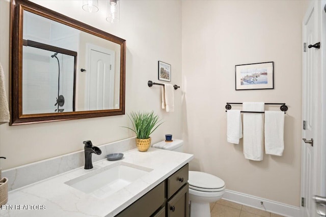 full bath featuring vanity, a shower with shower door, baseboards, tile patterned flooring, and toilet