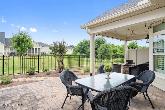 view of patio with outdoor dining space, a ceiling fan, and a fenced backyard