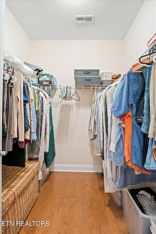 spacious closet with visible vents and wood finished floors