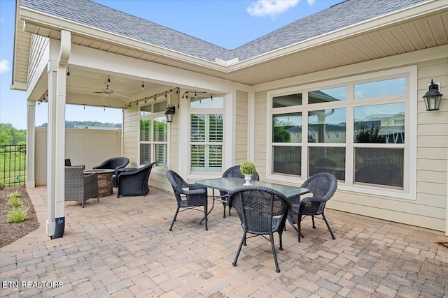 view of patio / terrace with outdoor dining area, ceiling fan, and fence