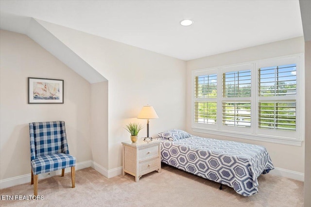 bedroom featuring light colored carpet and baseboards