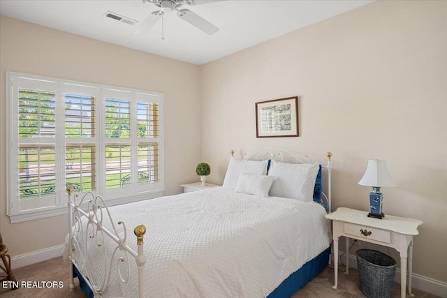 carpeted bedroom featuring visible vents, a ceiling fan, and baseboards