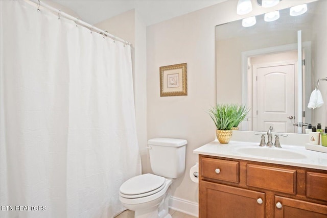 full bathroom with baseboards, toilet, vanity, and tile patterned flooring