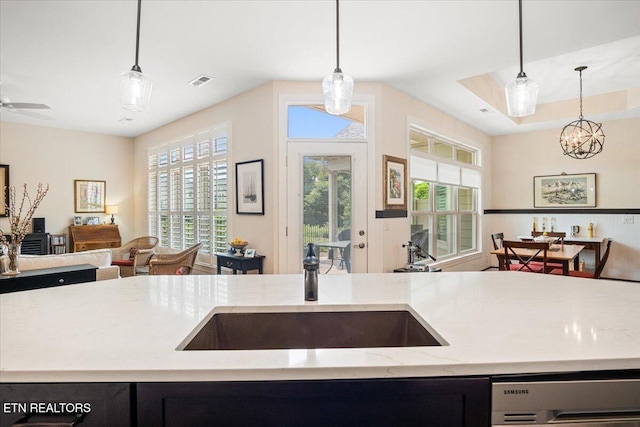 kitchen with a wealth of natural light, open floor plan, dishwashing machine, and a sink