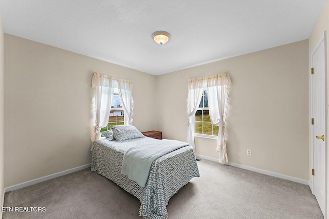 bedroom with carpet flooring and baseboards