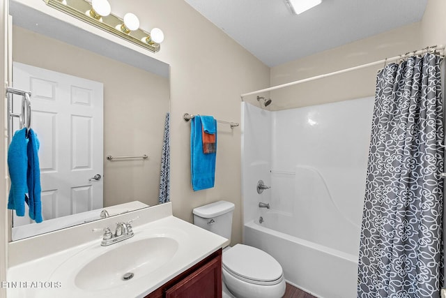 bathroom featuring vanity, shower / bath combination with curtain, and toilet