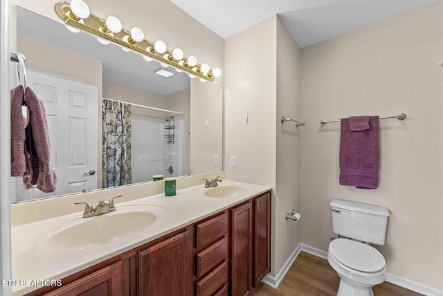 full bathroom with wood finished floors, toilet, a shower with curtain, and a sink