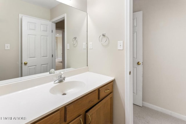 bathroom with vanity and baseboards