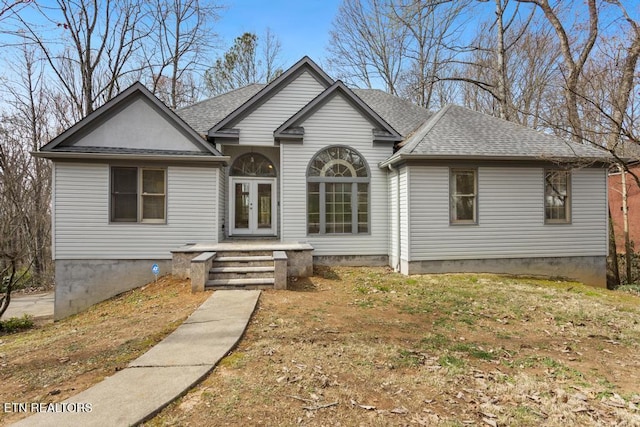 view of front of home featuring french doors and roof with shingles