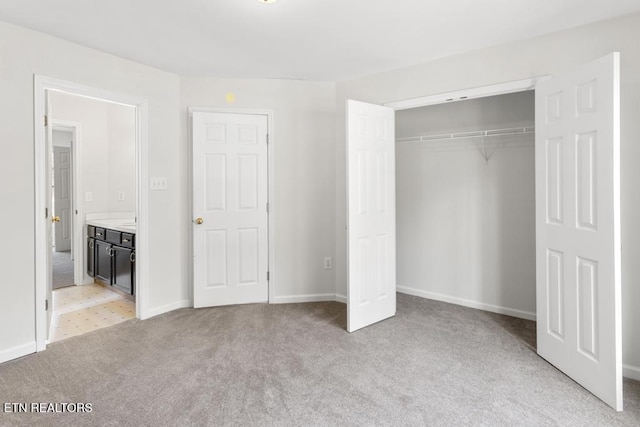 unfurnished bedroom with light carpet, baseboards, and a closet