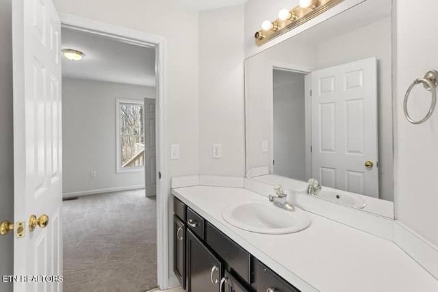 bathroom with vanity and baseboards