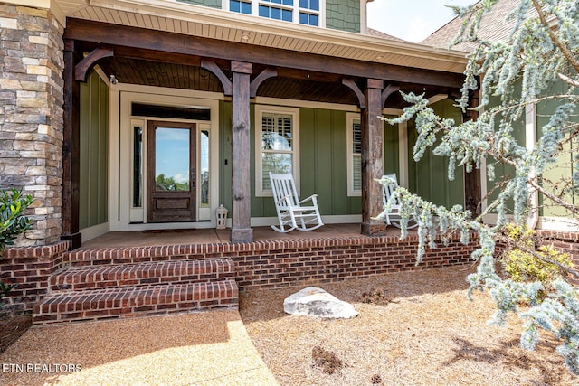 property entrance with stone siding and covered porch