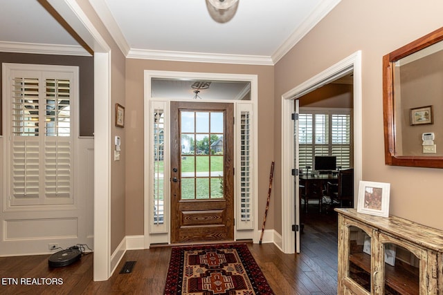 entryway with dark wood-style floors, crown molding, and baseboards