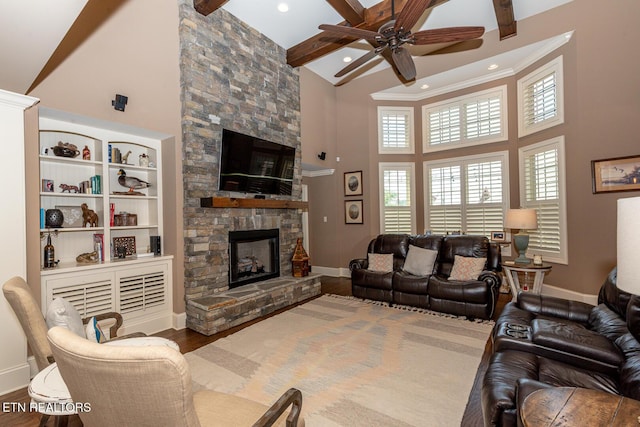 living room featuring beam ceiling, a fireplace, high vaulted ceiling, and wood finished floors