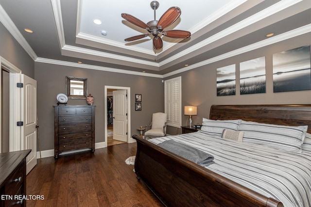 bedroom featuring baseboards, a raised ceiling, hardwood / wood-style floors, and ornamental molding