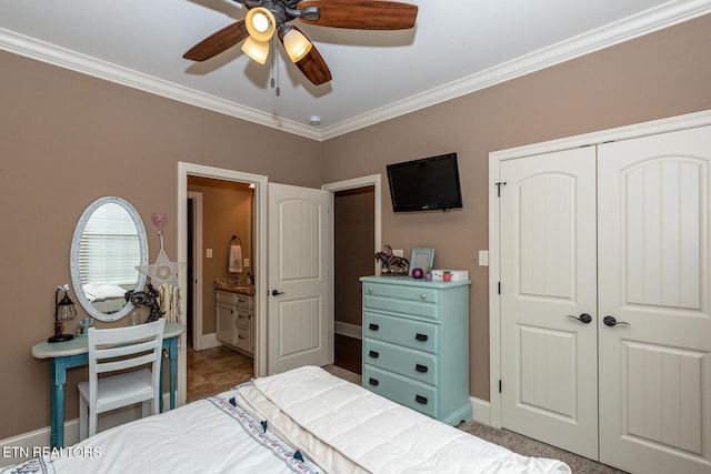 bedroom with a closet, crown molding, and baseboards