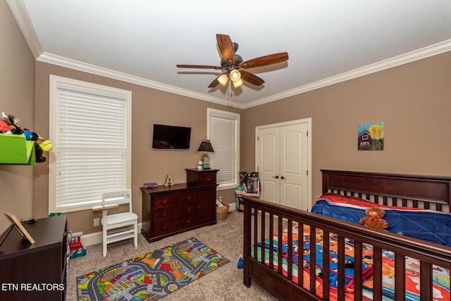 bedroom with carpet flooring, baseboards, a closet, and ornamental molding