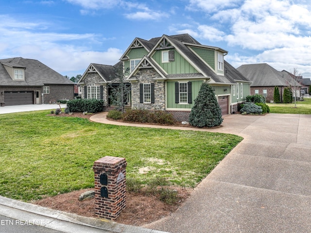 craftsman house featuring driveway, stone siding, board and batten siding, an attached garage, and a front yard