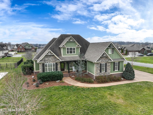 craftsman-style home with stone siding, covered porch, board and batten siding, and a front lawn