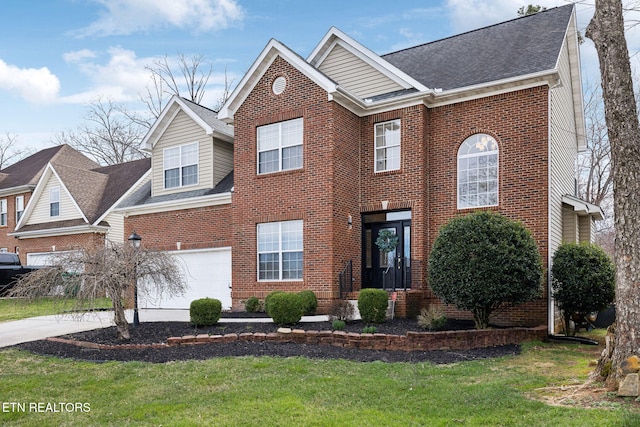 view of front of home featuring driveway, roof with shingles, a front yard, a garage, and brick siding