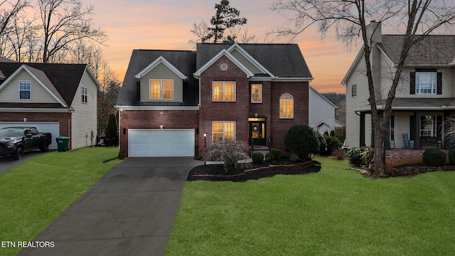 view of front of home featuring brick siding, an attached garage, concrete driveway, and a front lawn