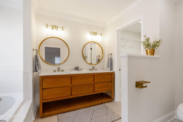 full bathroom with double vanity, a sink, tiled tub, and ornamental molding