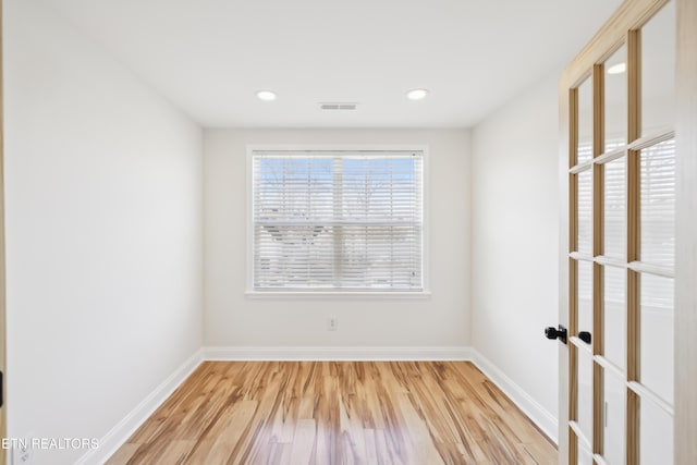 unfurnished room featuring recessed lighting, visible vents, baseboards, and wood finished floors