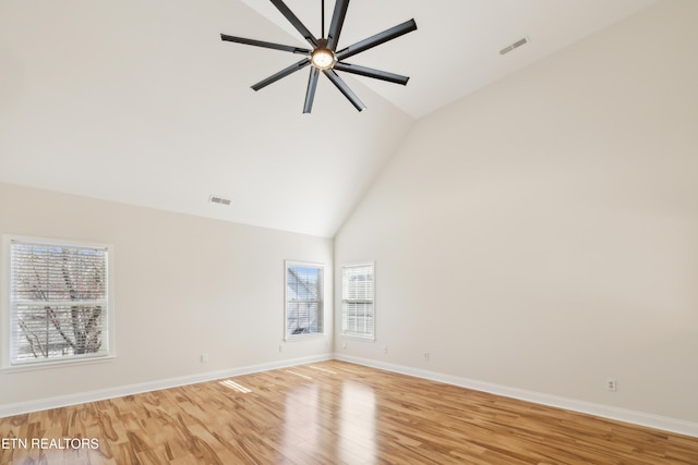 unfurnished room featuring visible vents, high vaulted ceiling, a ceiling fan, light wood-style floors, and baseboards