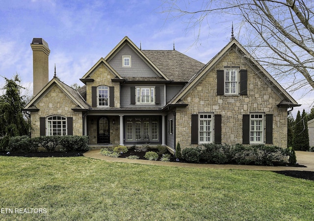 view of front of property featuring a chimney and a front yard