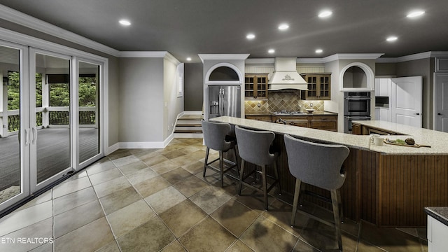 kitchen featuring ornamental molding, glass insert cabinets, appliances with stainless steel finishes, decorative backsplash, and custom exhaust hood