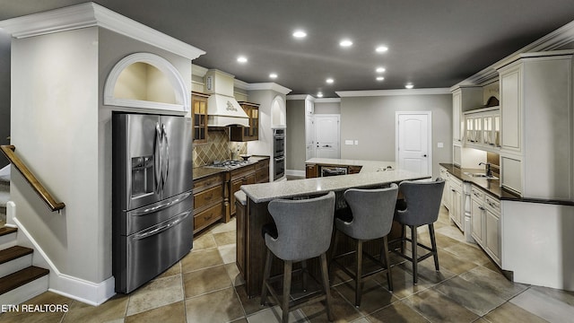 kitchen with backsplash, a center island, crown molding, premium range hood, and stainless steel appliances