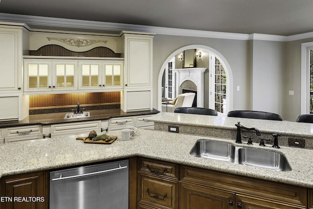 kitchen featuring a fireplace, a sink, glass insert cabinets, stainless steel dishwasher, and crown molding