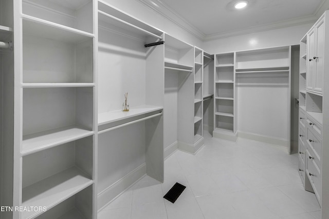 walk in closet with light tile patterned flooring