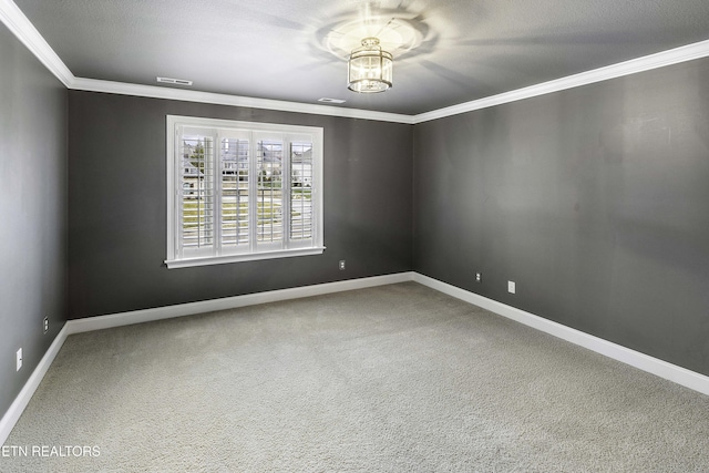 empty room featuring baseboards, visible vents, carpet floors, and ornamental molding