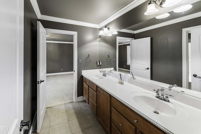 bathroom with crown molding, double vanity, tile patterned floors, and a sink