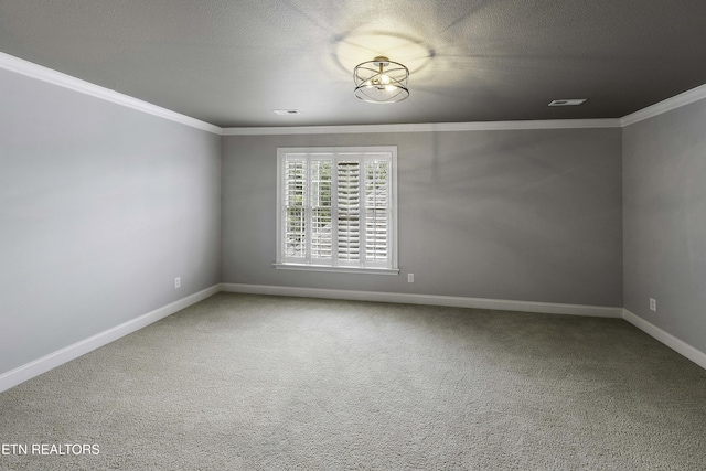 unfurnished room with visible vents, baseboards, carpet floors, a textured ceiling, and crown molding