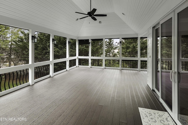 unfurnished sunroom with vaulted ceiling and a ceiling fan