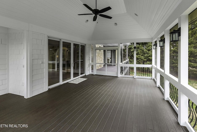 unfurnished sunroom featuring wooden ceiling, a ceiling fan, and vaulted ceiling