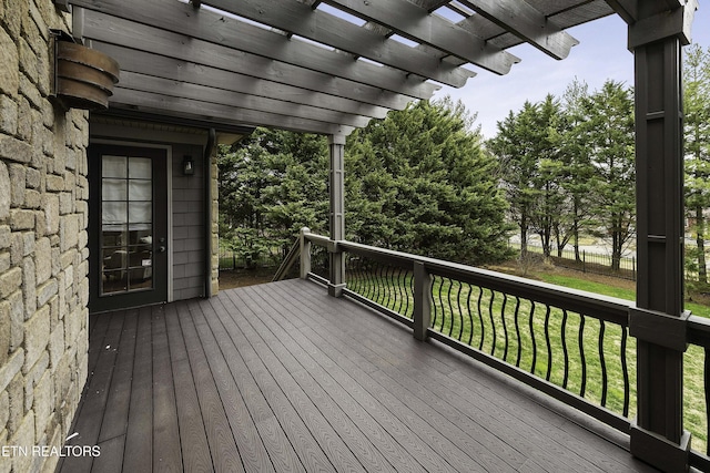 deck featuring a yard and a pergola