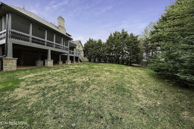 view of yard featuring stairs and a sunroom