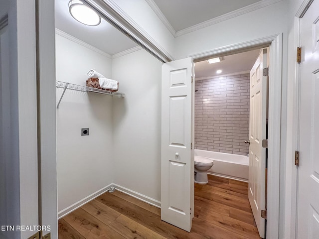 laundry room featuring crown molding, wood finished floors, laundry area, and electric dryer hookup