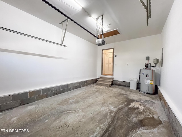 garage with a garage door opener and water heater