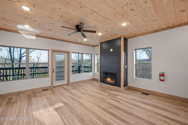 unfurnished living room with visible vents, baseboards, wood ceiling, light wood-style flooring, and a fireplace