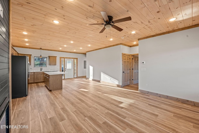 kitchen featuring light wood-type flooring, freestanding refrigerator, light countertops, wood ceiling, and open floor plan