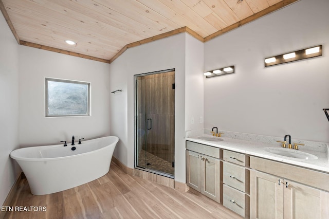 bathroom featuring wood finished floors, wood ceiling, a stall shower, and a sink