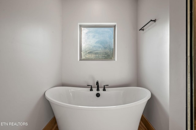 full bath featuring a freestanding bath